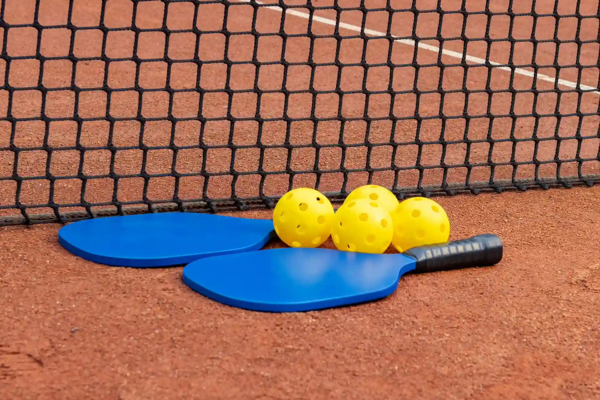 Seniors playing pickleball in West Palm Beach on outdoor courts