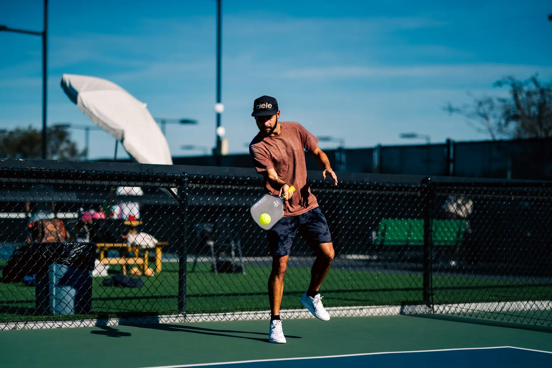 Coach Marco hitting a forehand drive during a private mobile pickleball lesson at a Houston-area court.