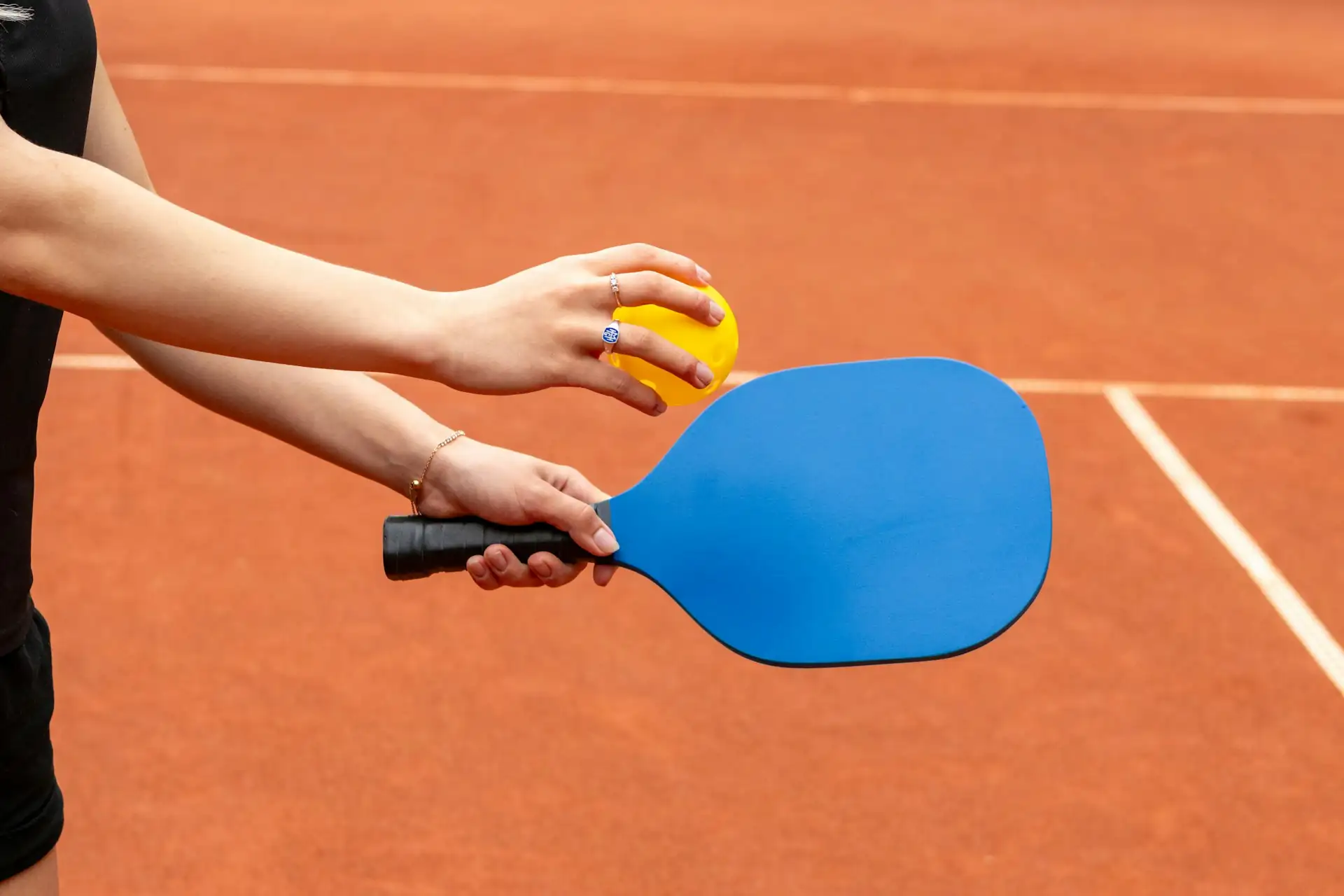 Pickleball players high-fiving during a Houston league match