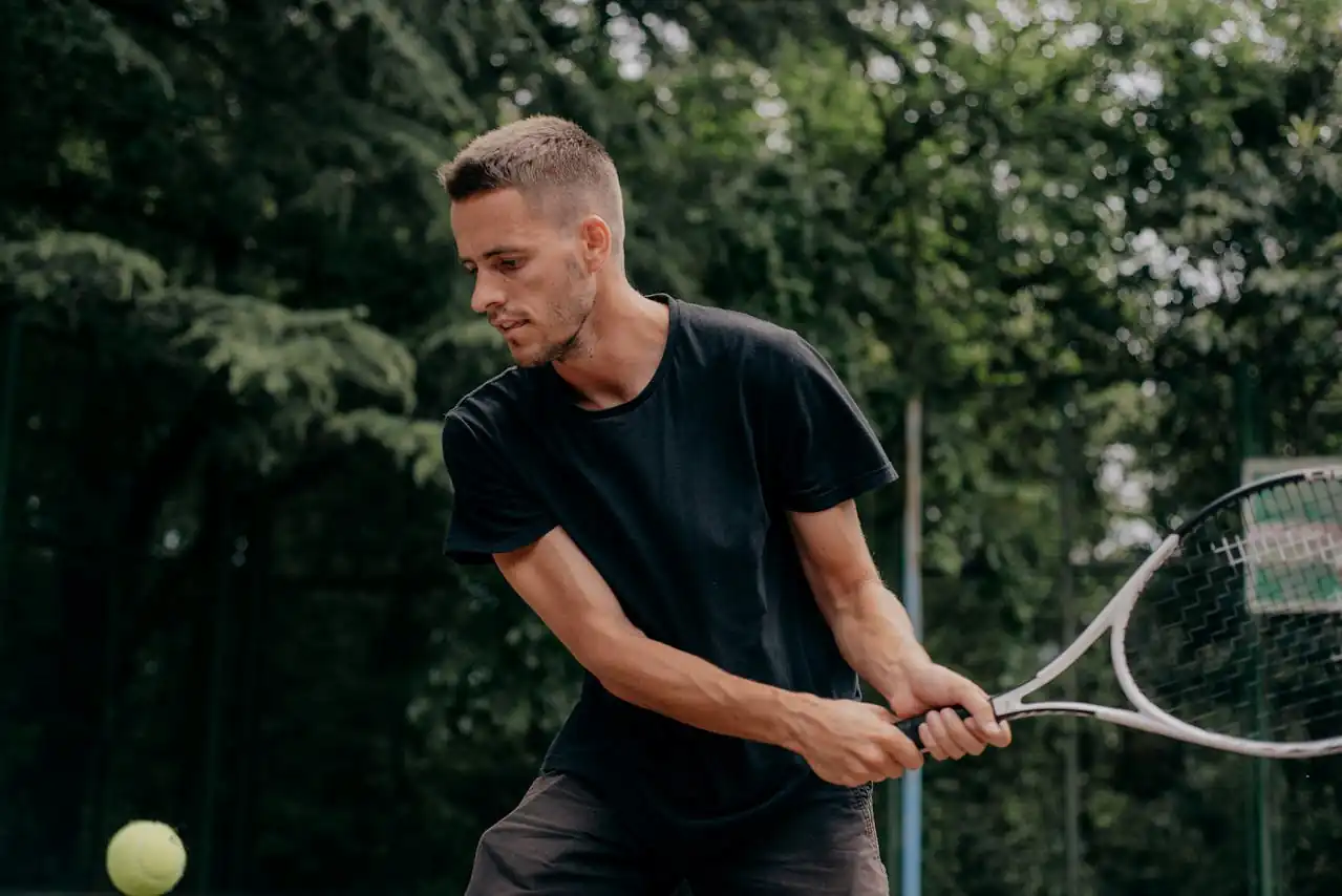 Private tennis coach in Houston, Texas teaching a forehand during a one-on-one lesson.