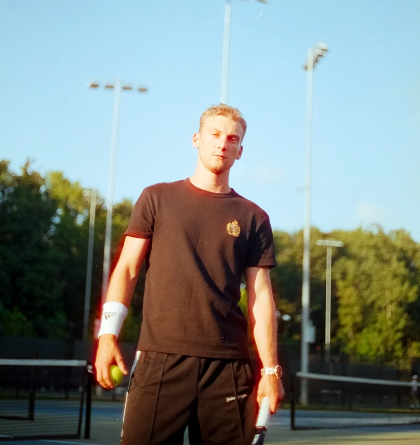 Private tennis trainer in Chicago, Illinois helping a player with technique during a lesson