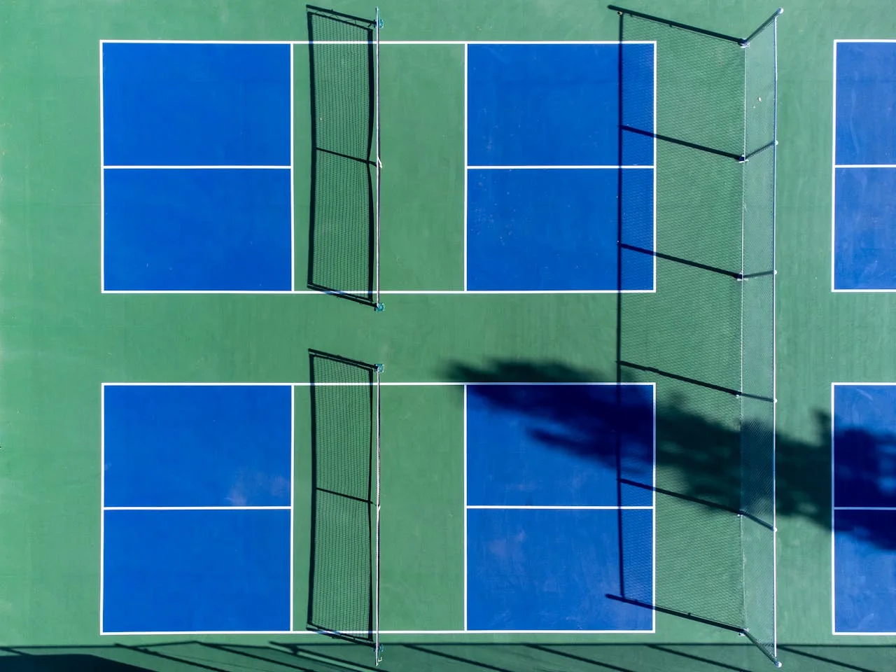 Aerial view of the massive Naples Pickleball Center in Southwest Florida, showing dozens of courts packed with players