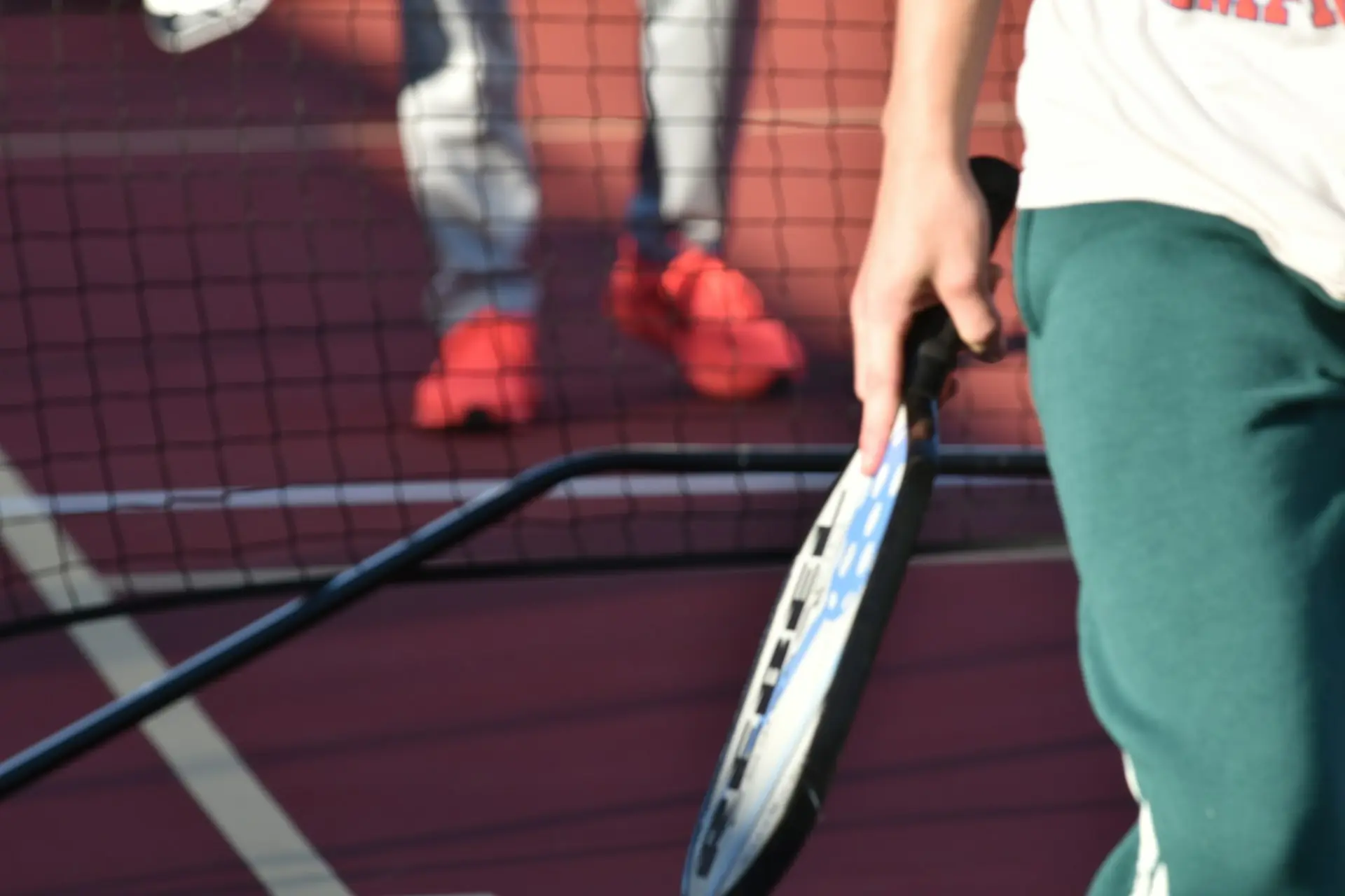 Close up of a pickleball player holding a paddle at a public park in Fort Worth