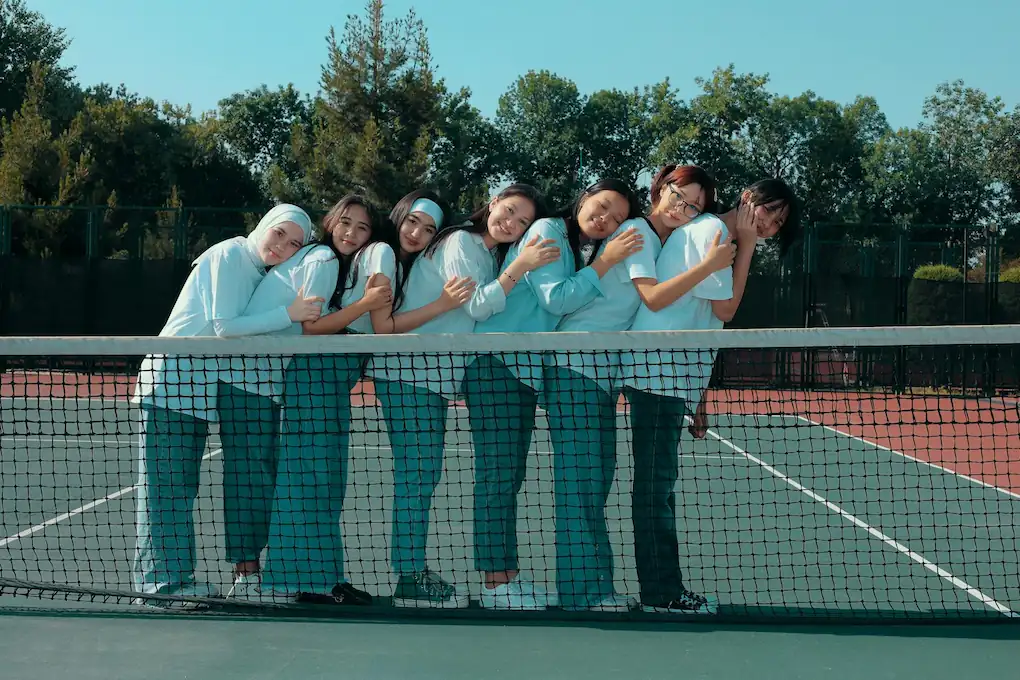 A women's tennis team posing for a photo after a Queen City Tennis League match in Charlotte