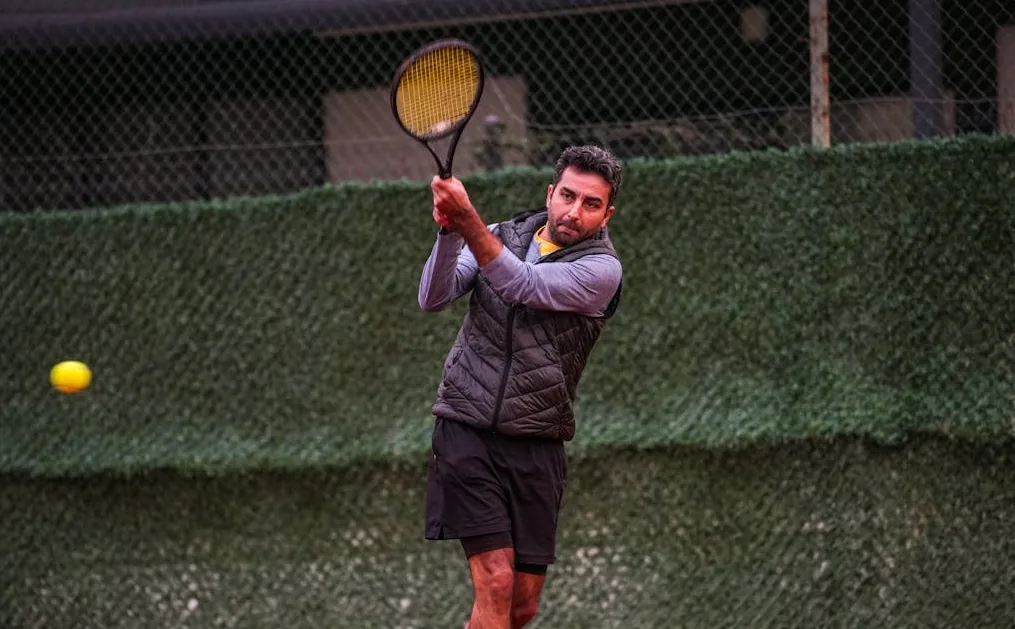Male tennis coach hitting during a private lesson in Phoenix, AZ.