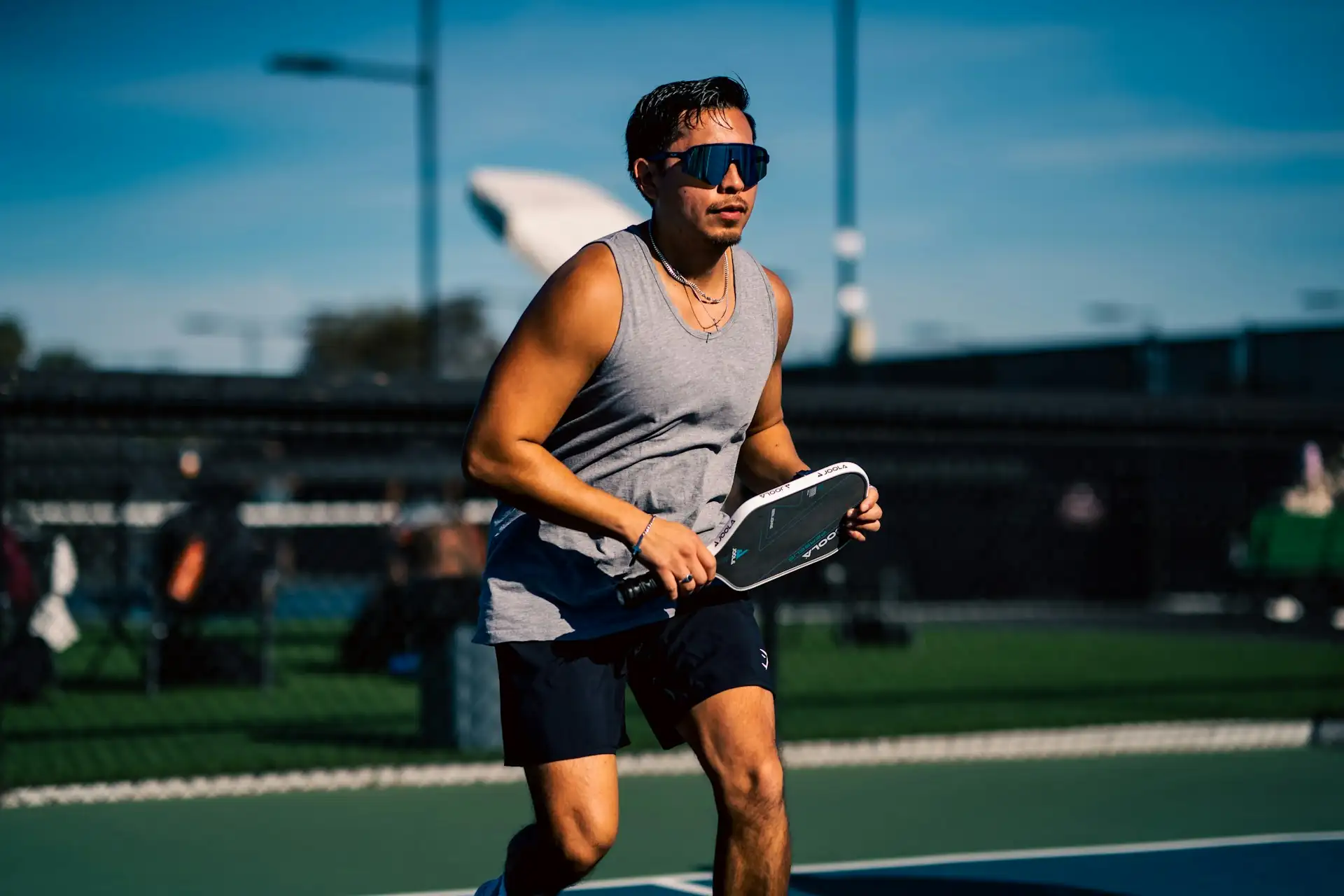 Coach Ken running with a paddle during a private pickleball lesson in Phoenix, Arizona, specializing in footwork and kitchen control.