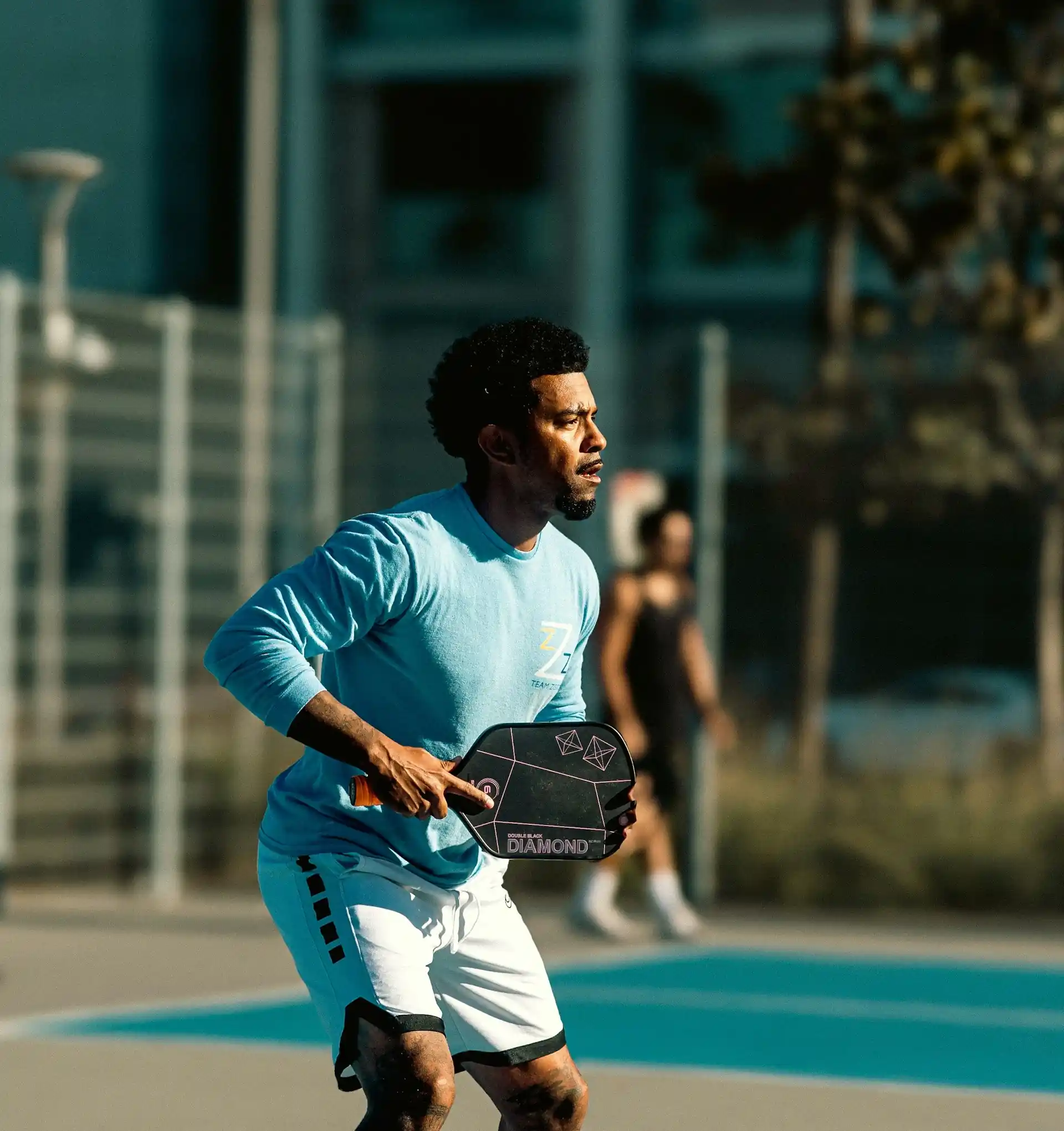 Coach Malik holding a pickleball paddle during a private lesson in Philadelphia, PA.