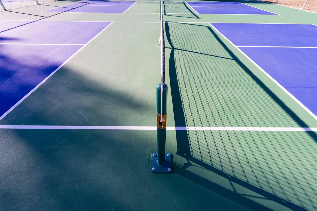 A busy public pickleball court in Charlotte, NC on a sunny day