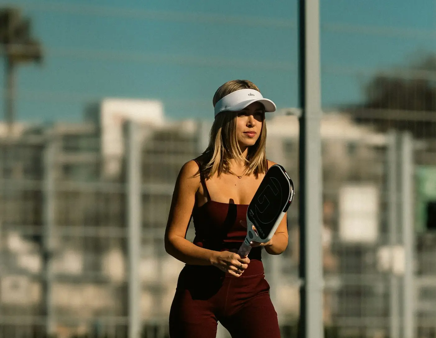 Female pickleball coach in Frisco coaching a private lesson for Golden Racket Academy clients.