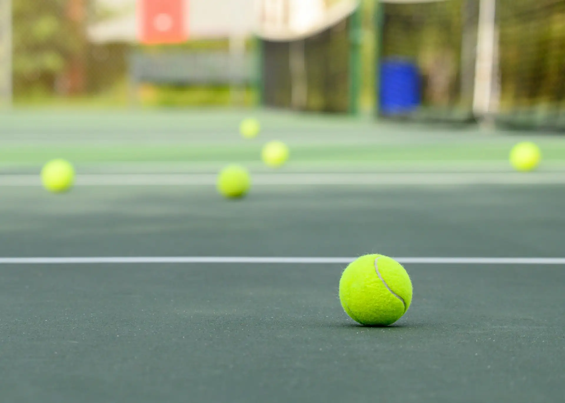 Fresh tennis balls on a hard court at Fretz Tennis Center in North Dallas