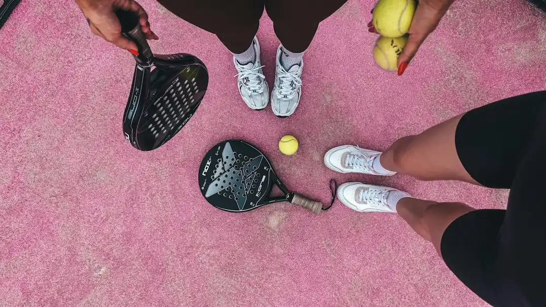 Two pickleball players waiting for a match during a social league night in Philadelphia