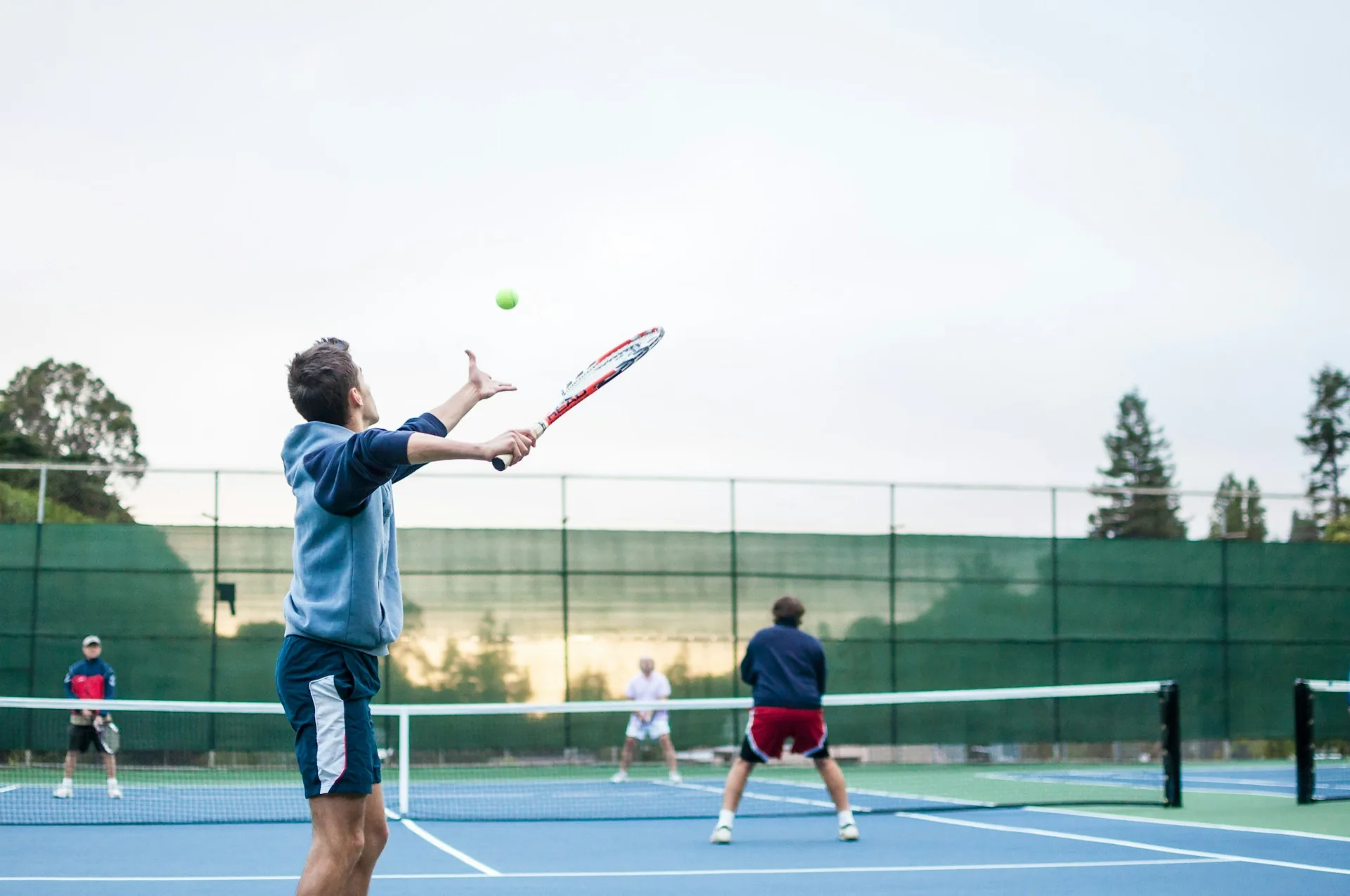 A busy public tennis court in Bonita Springs, FL, filled with players during the winter peak season