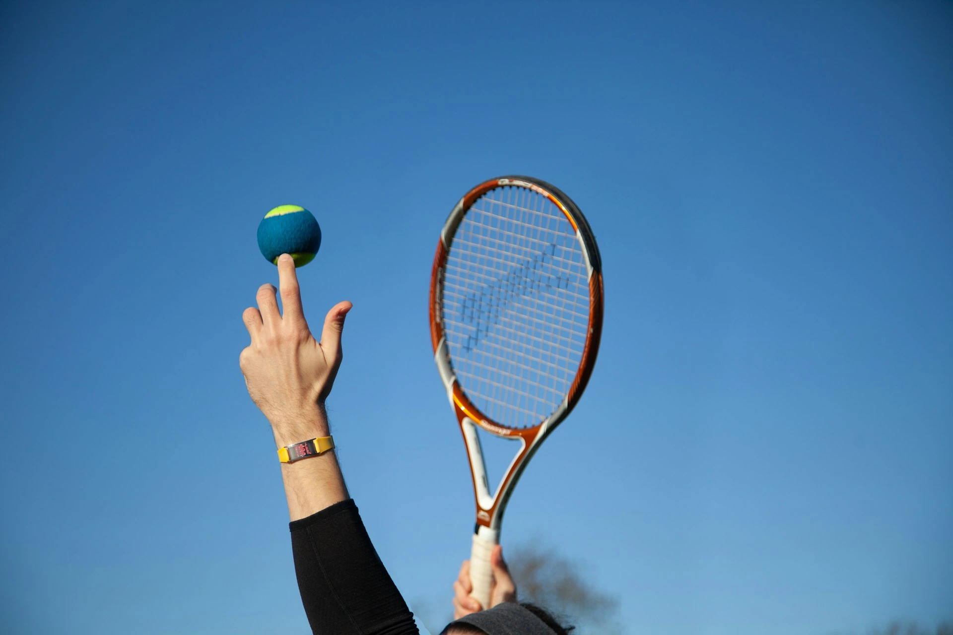 A dedicated tennis player serving under the Florida sun, ready to play despite the busy winter season crowds