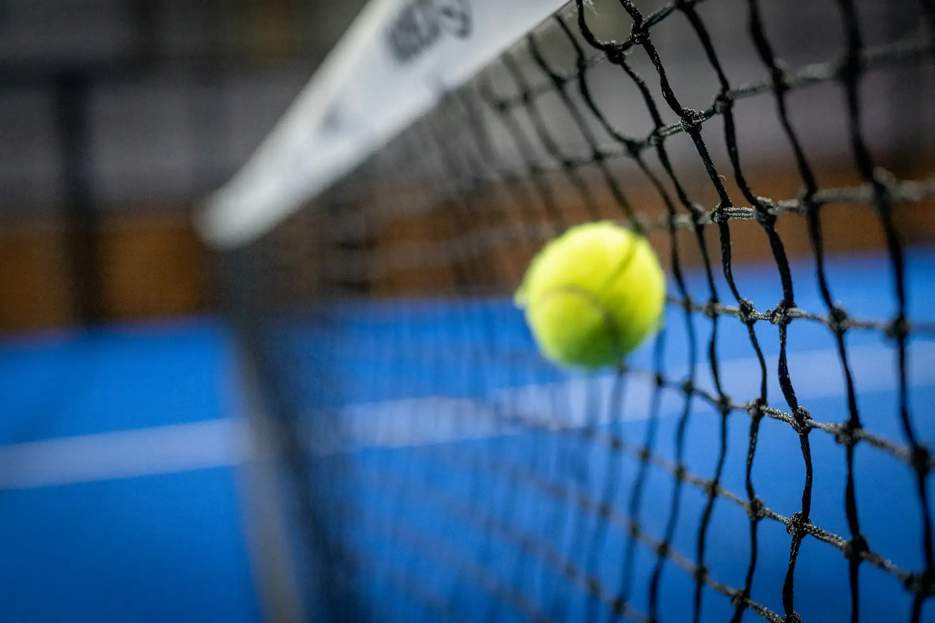 A tennis ball hitting the net cord during a competitive match at High Point Tennis Center in Plano