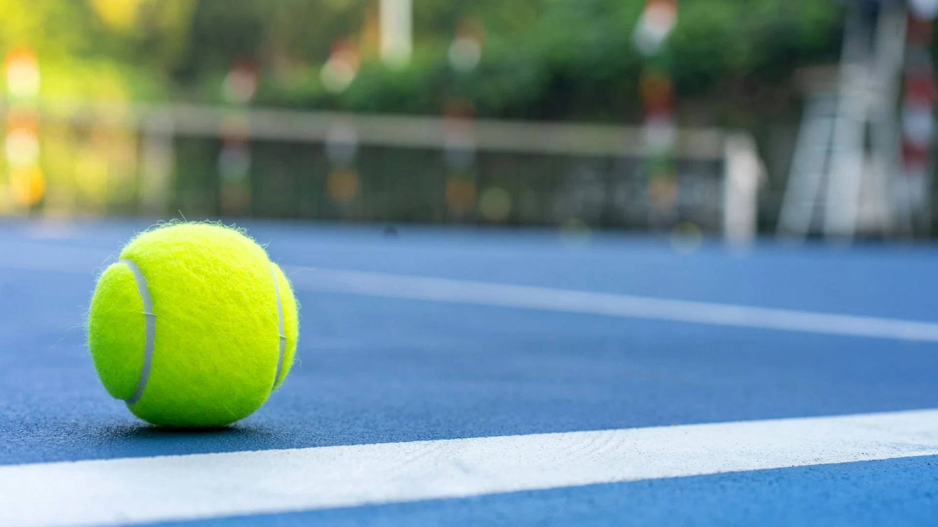 A close-up of a tennis ball on the pristine clay courts of Delray Beach, highlighting the premier surface quality