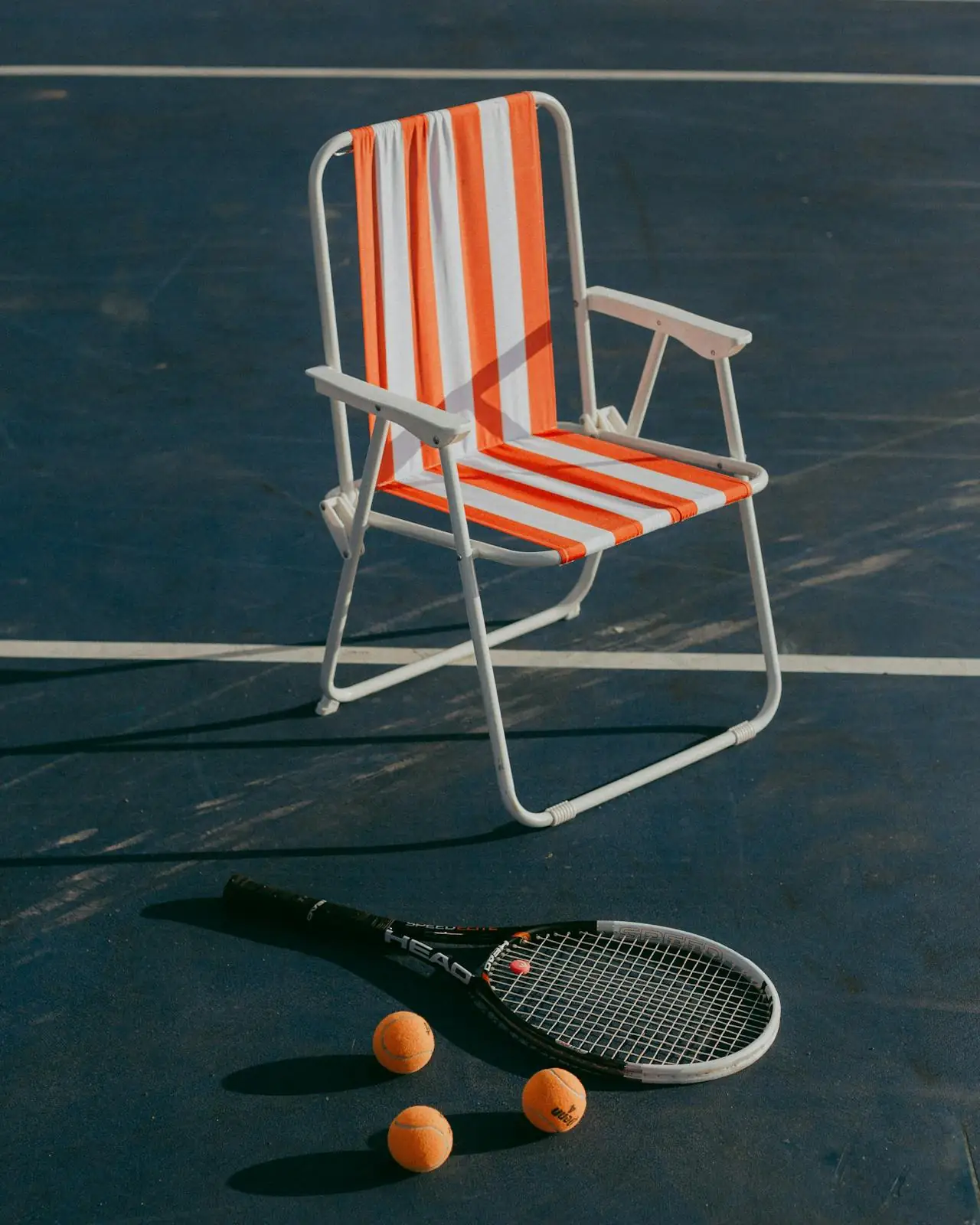 Tennis equipment resting on a court chair near the coast in Boca Raton, capturing the relaxed East Boca lifestyle