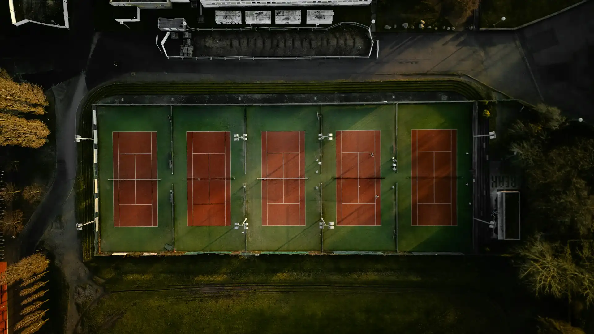 A busy league match day at a Fort Worth tennis facility with multiple courts in action
