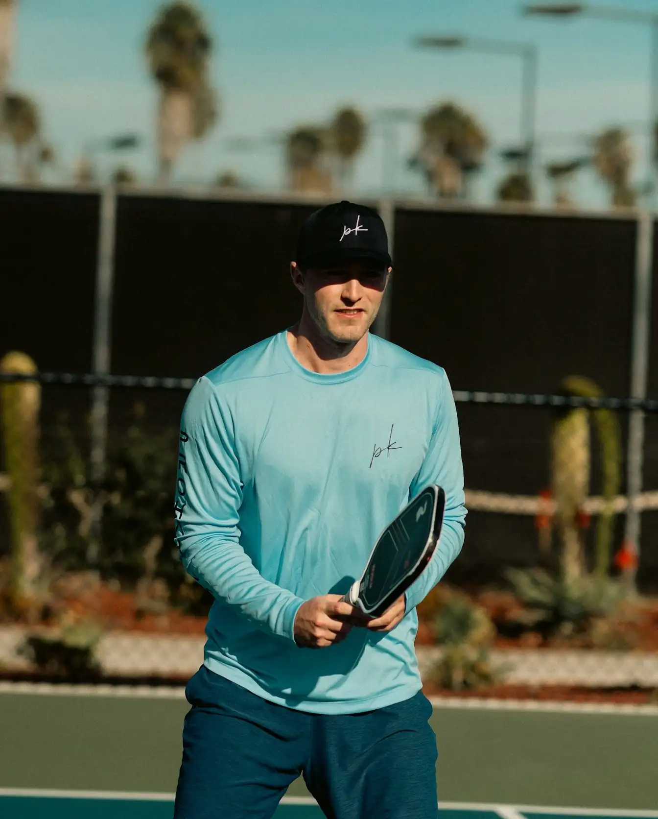 Coach Daniel holding a paddle during a private mobile pickleball lesson in Phoenix, Arizona.