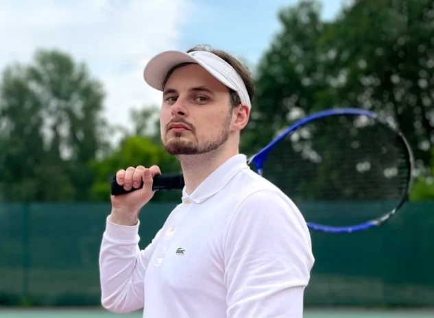 Coach Ryan, private tennis instructor in Frisco, Texas, posing courtside before a lesson.