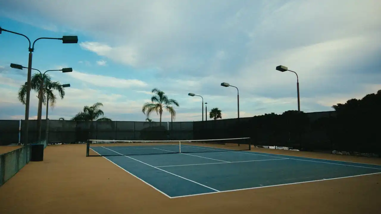 Pristine blue tennis courts at a Frisco ISD high school facility, available for public booking