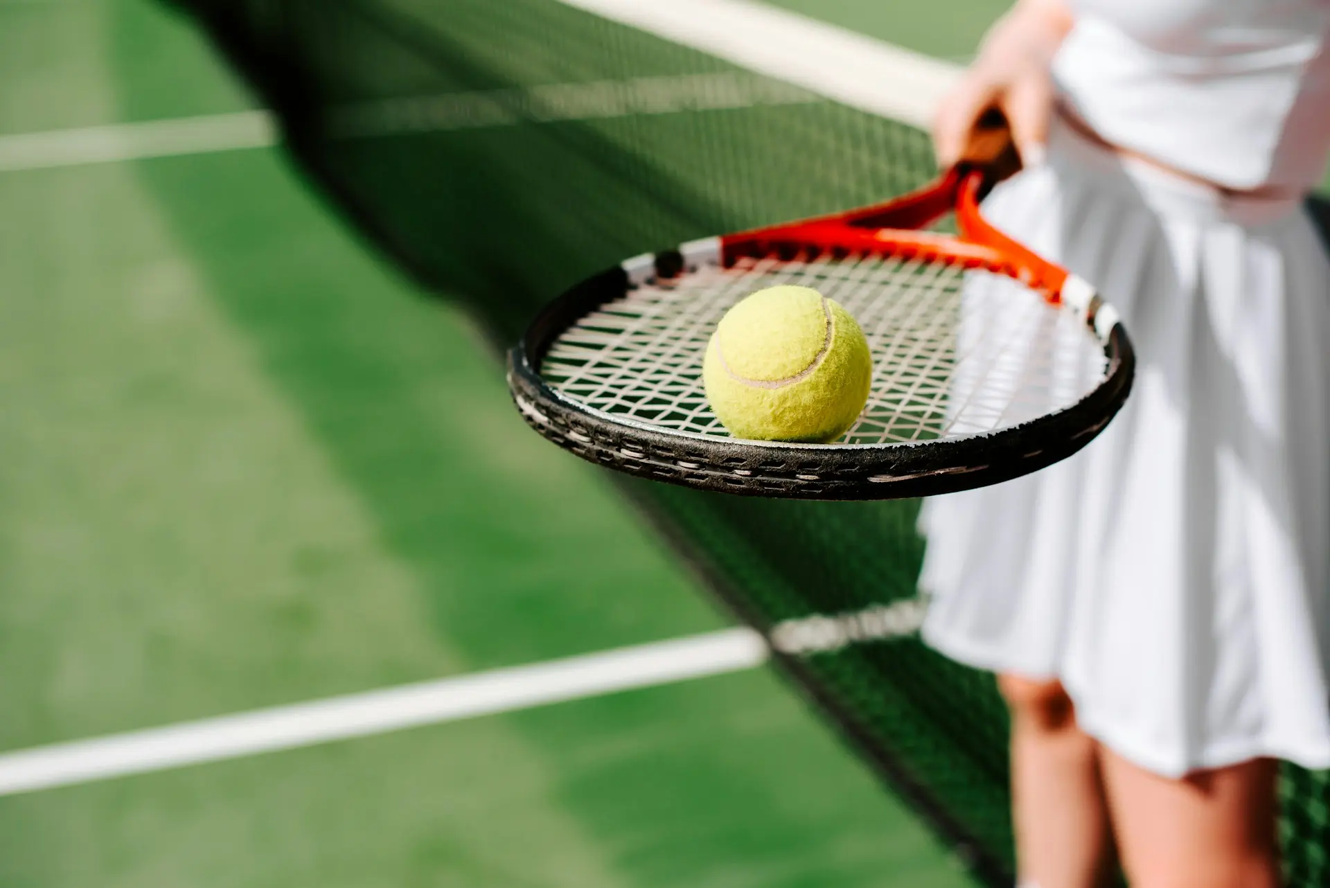 A tennis player standing on the center court of the Delray Beach Stadium, preparing to serve in an 8,200-seat arena